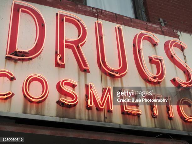 closeup of vintage drugstore cosmetics sign in the east village in manhattan, new york city - east village stock-fotos und bilder