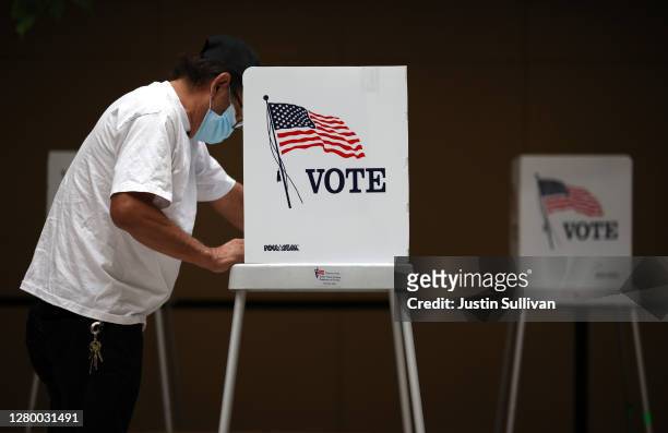 Voter fills out his ballot while early voting at the Santa Clara County registrar of voters office on October 13, 2020 in San Jose, California. The...