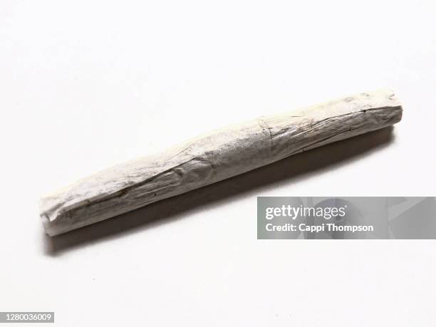 cannabis joint over a white background - joint stock-fotos und bilder