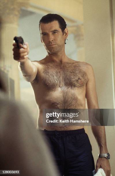 Irish actor Pierce Brosnan as 007 in the James Bond film 'GoldenEye', 1995. Here he confronts an assailant in a sauna.