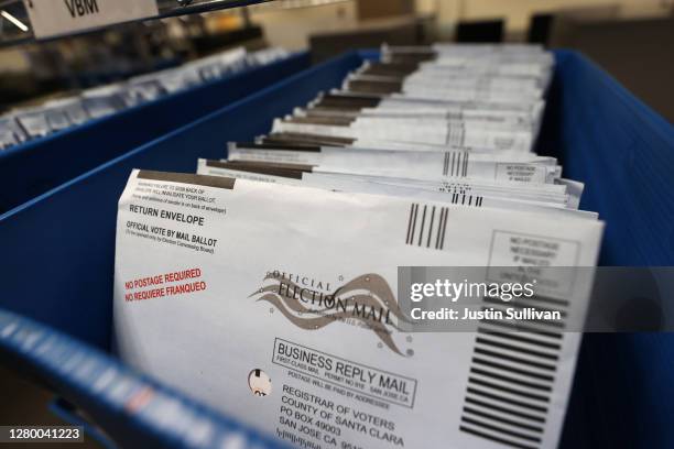 Mail-in ballots sit in trays before being sorted at the Santa Clara County registrar of voters office on October 13, 2020 in San Jose, California....