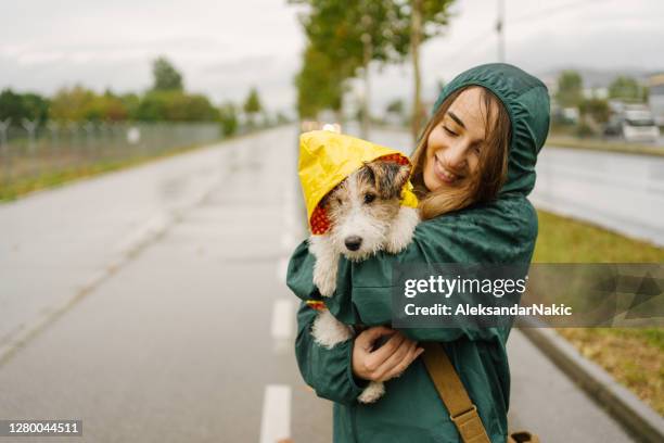 walking my dog on a rainy day - rain coat stock pictures, royalty-free photos & images