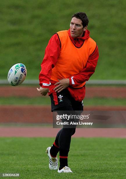 Utility back James Hook Passes the ball during a Wales IRB Rugby World Cup 2011 media session at Newtown Park on October 5, 2011 in Wellington, New...