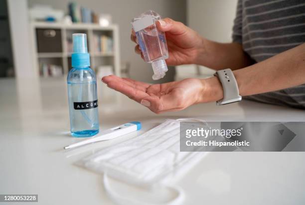 close-up on a woman applying antibacterial hand sanitizer - biosecurity stock pictures, royalty-free photos & images