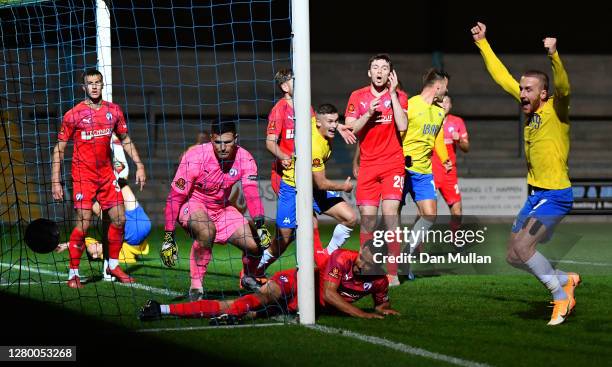 Torquay United players celebrate as a shot from Asa Hall of Torquay United finds its way over the line during the Vanarama National League match...