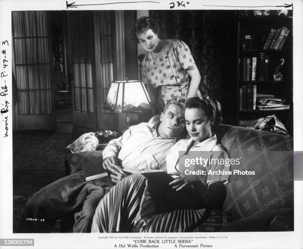 Shirley Booth looks over Richard Jaeckel and Terry Moore's shoulder while they are reading in a scene from the film 'Come Back Little Sheba', 1952.