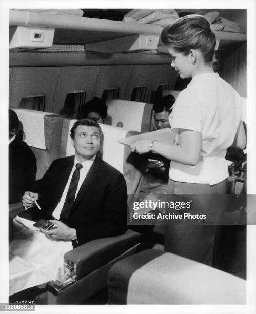 Karl Boehm cannot take his eyes off the pretty air hostess in a scene from the film 'Come Fly With Me', 1963.