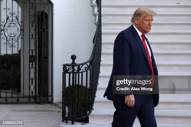 President Donald Trump comes out from the residence prior to a Marine One departure from the White House October 13, 2020 in Washington, DC....