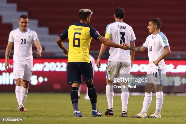 Cristhian Noboa of Ecuador greets Lucas Torreira of Uruguay after a match between Ecuador and Uruguay as part of South American Qualifiers for Qatar...