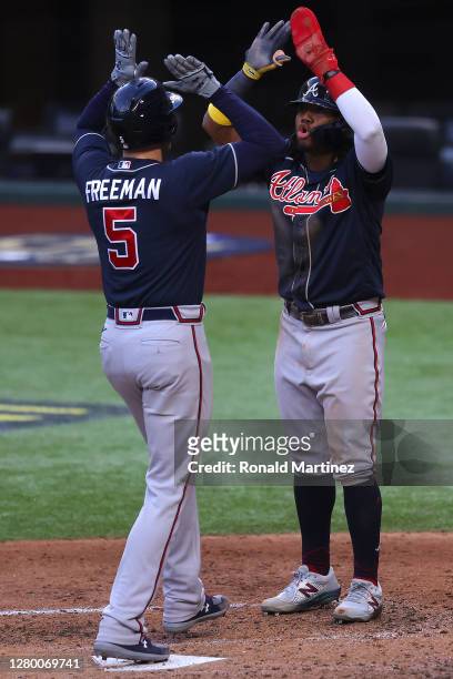 Freddie Freeman of the Atlanta Braves is congratulated by Ronald Acuna Jr. #13 after hitting a two run home run against the Los Angeles Dodgers...