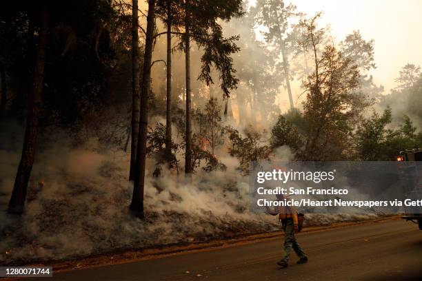 Forest Service firefighter takes part in a firing operation along Limantour Road while Woodward Fire burns in Point Reyes National Seashore in Marin...