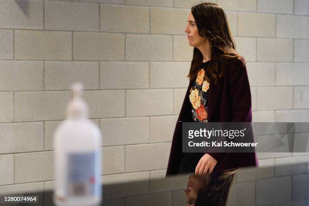 New Zealand Prime Minister Jacinda Ardern walks past a bottle of hand sanitiser before speaking to the media following a walkabout in the CBD on...