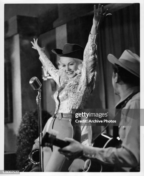 Mamie Van Doren and Neil Levang perform on the stage in a scene from the film 'Born Reckless', 1958.