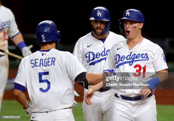 Corey Seager of the Los Angeles Dodgers is congratulated by Joc Pederson and Chris Taylor after hitting a three run home run against the Atlanta...