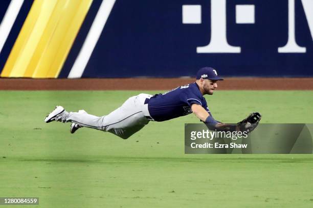 Kevin Kiermaier of the Tampa Bay Rays dives to catch a ball hit by Carlos Correa of the Houston Astros during the third inning in Game Three of the...