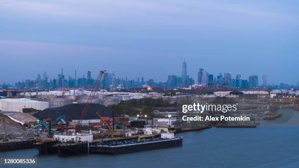 aerial views of the commercial docs near bayonne, new jersey, with new york city in the background. - bayonne new jersey stock pictures, royalty-free photos & images