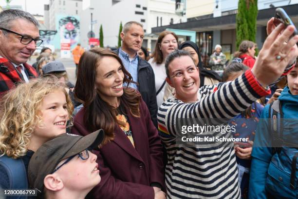 New Zealand Prime Minister Jacinda Ardern poses for a selfie with a member of the public during a walkabout in the CBD on October 14, 2020 in...