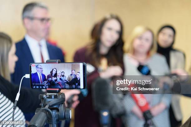 Detail view of a mobile screen as New Zealand Prime Minister Jacinda Ardern speaks to the media following a walkabout in the CBD on October 14, 2020...