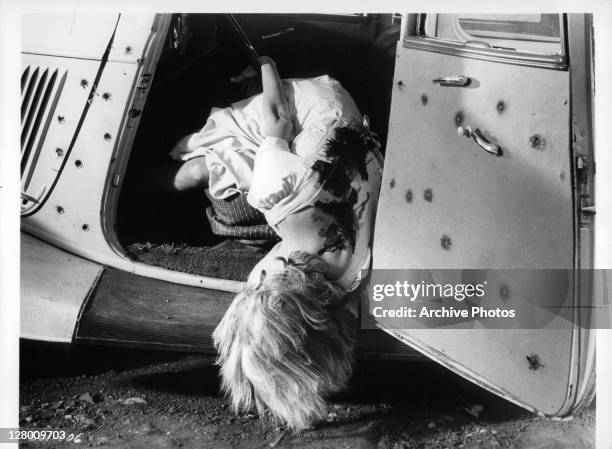 Actress Faye Dunaway lying dead in a car in a scene from the film 'Bonnie And Clyde', 1967.