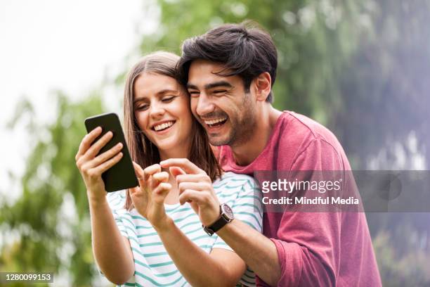 couple using smart phone - argentina friendly stock pictures, royalty-free photos & images