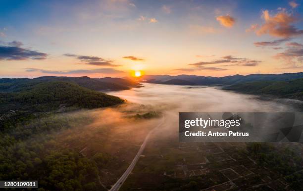 panorama of a misty dawn in the mountains. korcula island, croatia - korcula island stock pictures, royalty-free photos & images