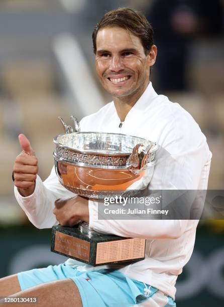 Rafael Nadal of Spain poses with the winners trophy following victory in his Men's Singles Final against Novak Djokovic of Serbia on day fifteen of...
