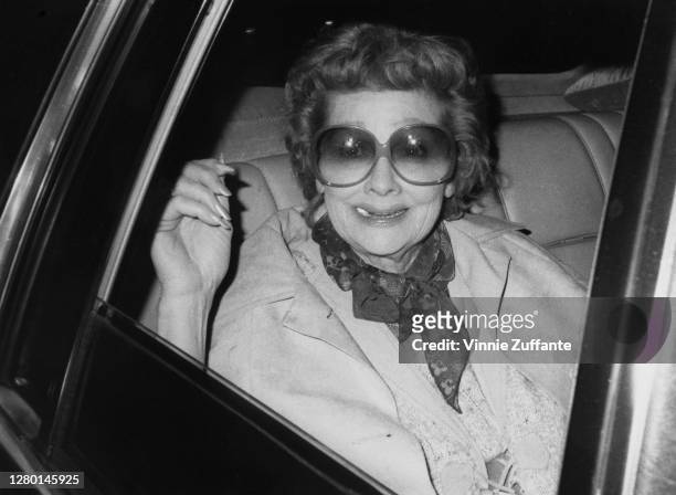 American actress and comedian Lucille Ball travelling in the back of a car after the recording of ABC television special 'Night of 100 Stars II' in...