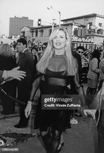 American actress Kim Basinger attends the premiere of 'Batman', held at the Mann Village Theater in Los Angeles, California, 19th June 1989. Mario's...