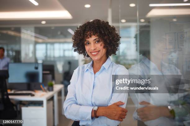mid adult business woman with arms crossed in call center - vice president office stock pictures, royalty-free photos & images