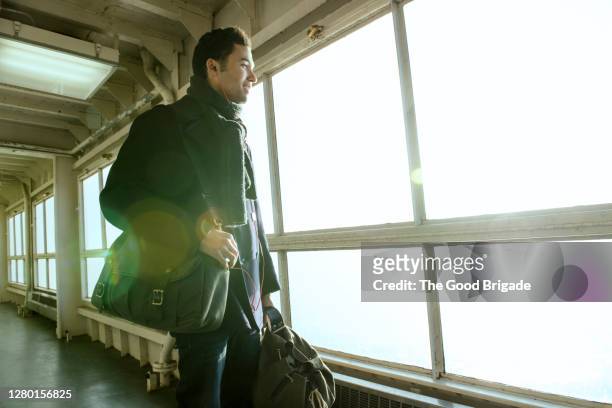young man disembarking passenger ferry - ferry passenger stock pictures, royalty-free photos & images