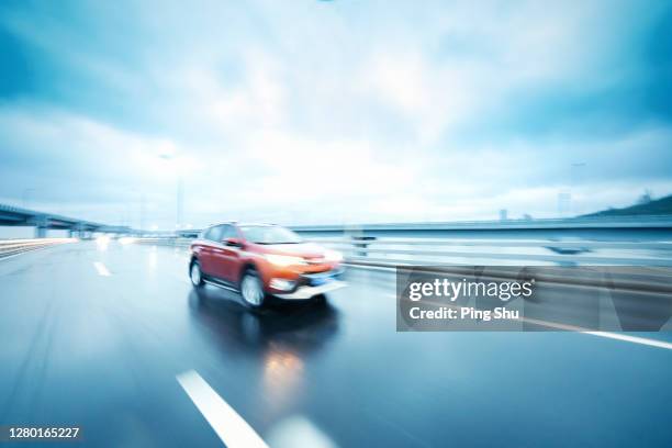 a car on the road - car advertisement stock pictures, royalty-free photos & images