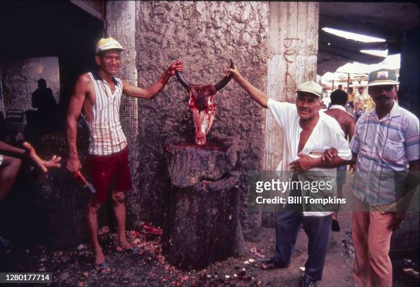 May 1987]: MANDATORY CREDIT Bill Tompkins/Getty Images Butchers posing with steer's head. The city of Cartagena, known in the colonial era as...