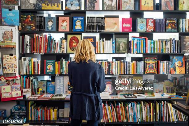 female customer at a bookstore - navy blue interior stock pictures, royalty-free photos & images