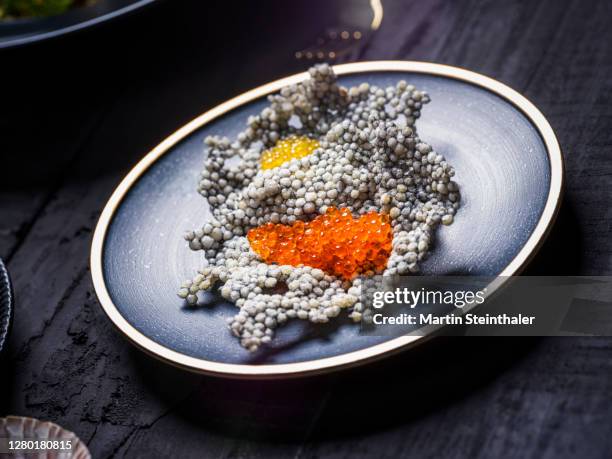 orangener und gelber kaviar abstrakt dekoriert auf rustikalem untergrund - caviar 個照片及圖片檔