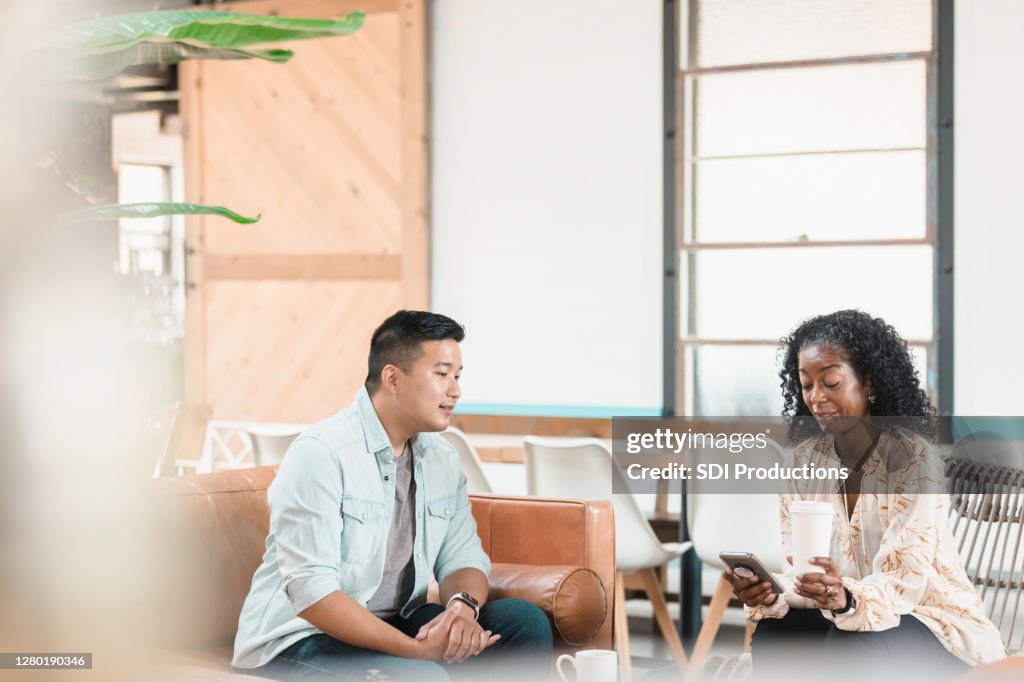 Collegue Check In Mid Adult Male Waits While Female Colleague Checks Email High-Res Stock ...