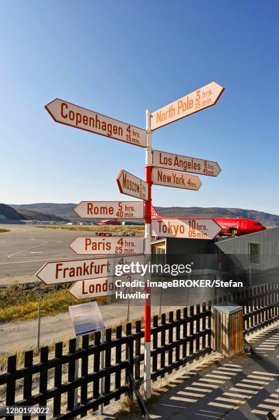 international names of capitals on signposts next to the runway, airport, kangerlussuaq, greenland - kangerlussuaq bildbanksfoton och bilder