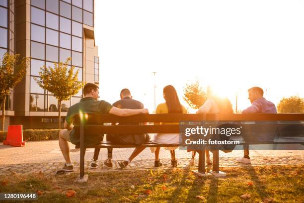 rear view of friends with prosthetic legs sitting - calf stretch stock pictures, royalty-free photos & images