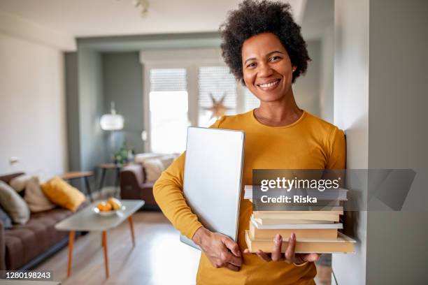portrait of female professor at home - holding book stock pictures, royalty-free photos & images