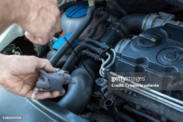 fixing in car at home - mecanico stockfoto's en -beelden