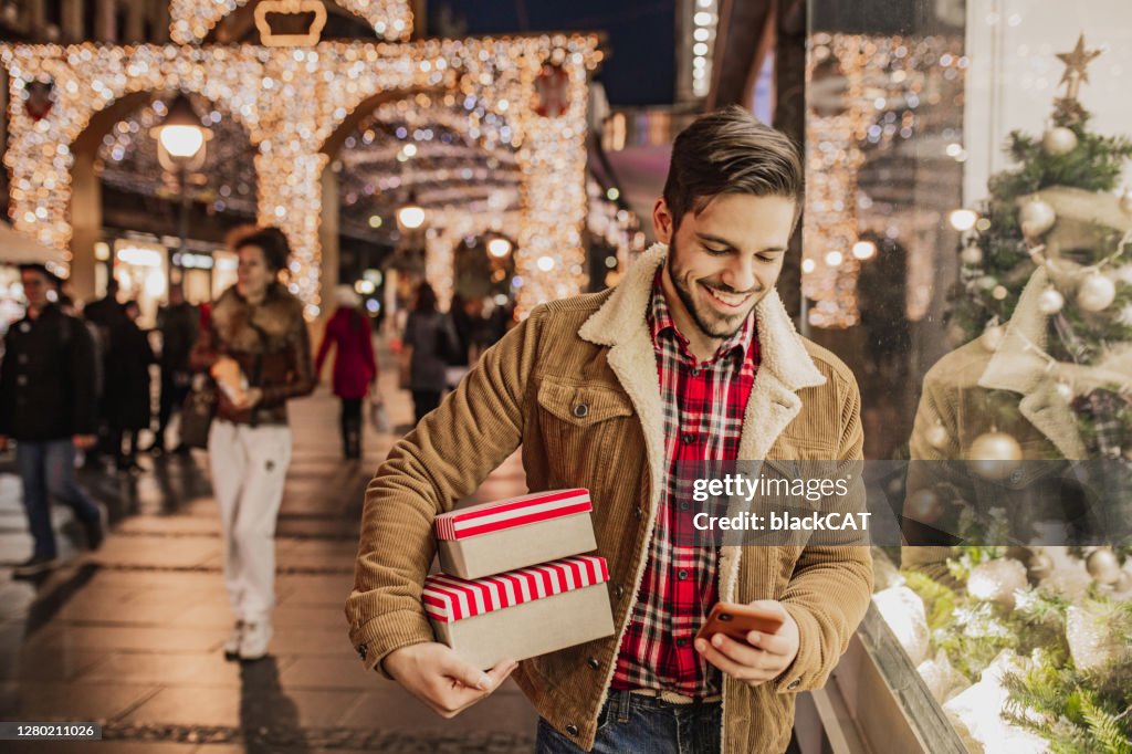 Young man in Christmas shopping