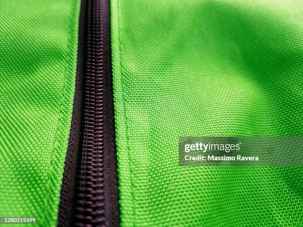 black zip on green fabric. - embellished jacket stock pictures, royalty-free photos & images