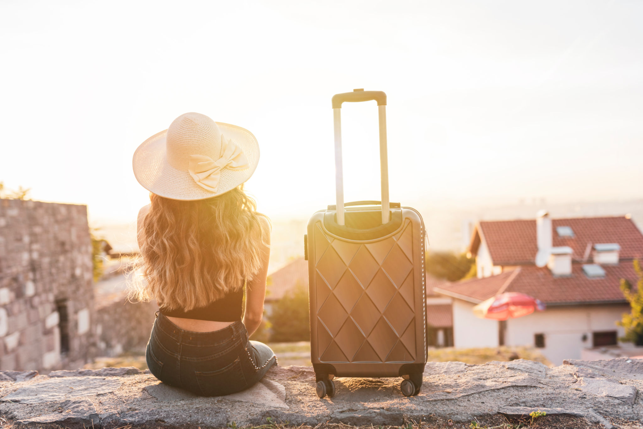 young blonde woman with suitcase travel on street young blonde woman with suitcase travel on street
