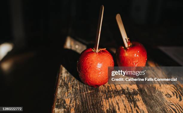 two candy apples on a wooden table - corn syrup stock pictures, royalty-free photos & images