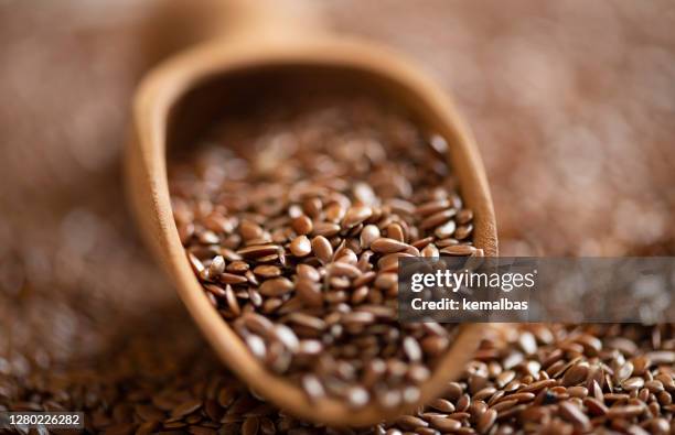 brown flax seeds in the wooden shovel - flax seed stock pictures, royalty-free photos & images