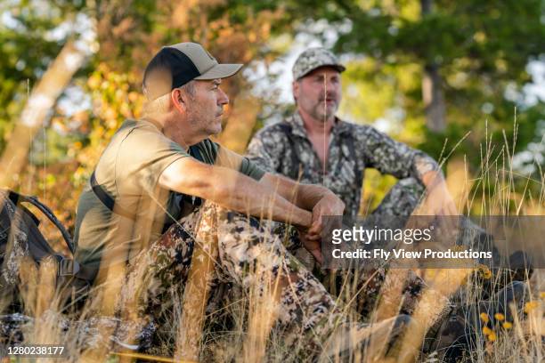 hunters sitting in forest while hunting - bow hunting stock pictures, royalty-free photos & images