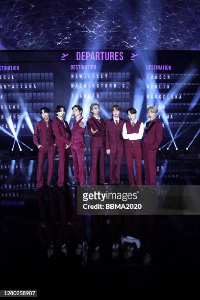 In this image released on October 14, J-Hope, Jungkook, V, RM, Jin, Suga, and Jimin of BTS perform onstage at the 2020 Billboard Music Awards,...