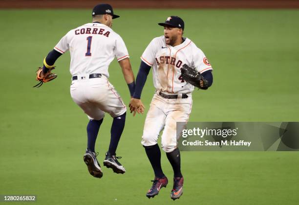 Carlos Correa and George Springer of the Houston Astros celebrates a 4-3 win against the Tampa Bay Rays in Game Four of the American League...