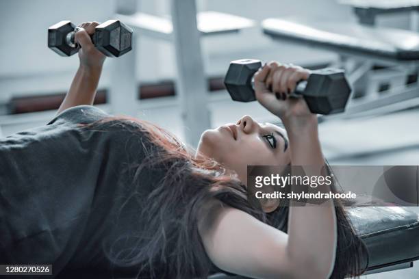 asian young women working out at the gym - human muscle stock pictures, royalty-free photos & images