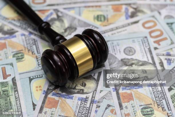 money and hammer,wooden gavel and dollar banknotes - luogo dabitazione foto e immagini stock