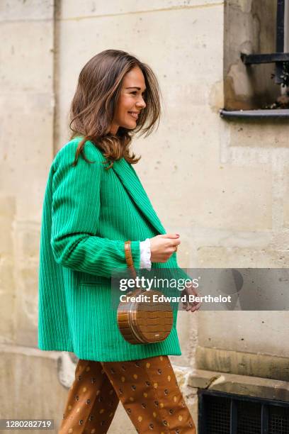 Therese Hellström wears a brown leather crocodile pattern bag from Cafune, an all Paul & Joe outfit made of an oversized corduroy green blazer...